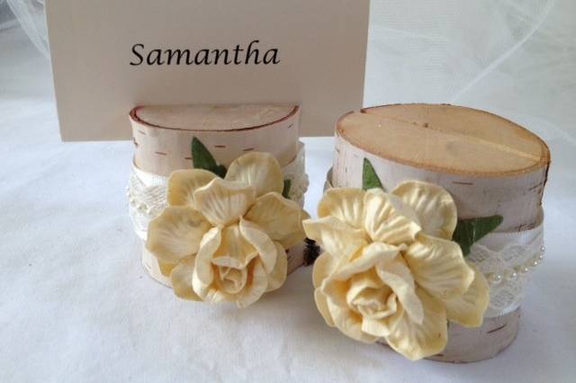 Beautiful french vanilla cream roses with ivory and pearl satin ribbon make these place card holders simply timeless, and will be beautiful in any wedding or rehearsal dinner. This listing is for a set of 10 natural birch wood place card holders for $35.00They are 2 inches tall, and approximately 2 - 2 1/2 inches wide. Each holder has a 3/8 inch slot on the top which holds the place card nicely. Each piece is hand crafted so no two are alike!Use these at weddings, rehearsal dinners, baby showers, and really any party event that you want some additional sparkle to your table. Mixing and matching styles is a beautiful table design statement.if you don't see what you are looking for, just send us a message and we are happy to create that special look for you.Keep it rustic chic!Tutti Rose DesignsBe sure to visit www.etsy.com/shop/tuttirosedesigns to see our entire collection.