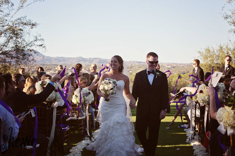 The guests congratulated the bride and groom with purple wedding wands