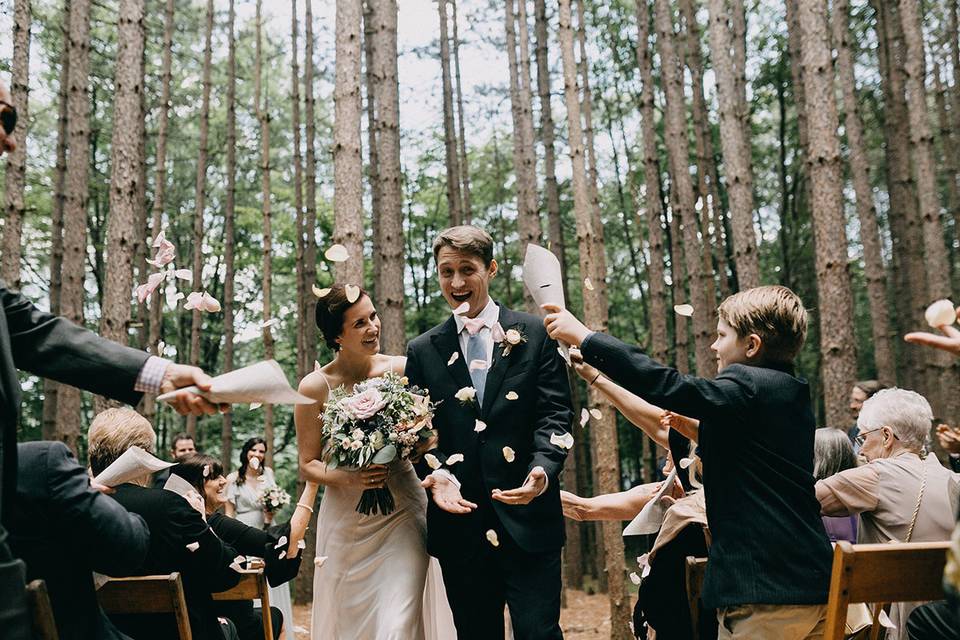 Wedding ceremony in the pine grove at The Roxbury Barn and Estate in the Central Catskills. Photo by Emily Delamater.