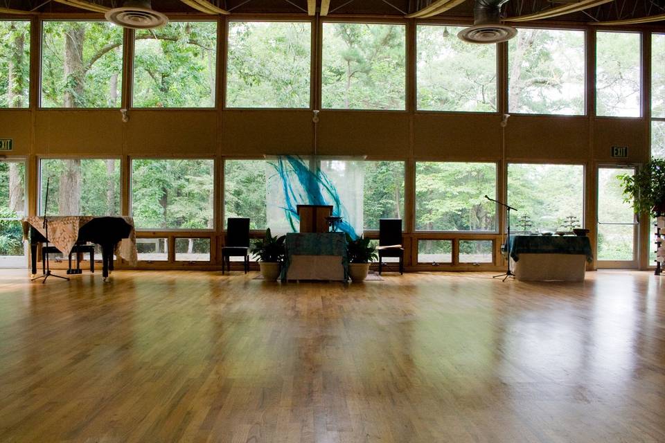 Sanctuary with beautiful floor to ceiling windows that overlook the woods.