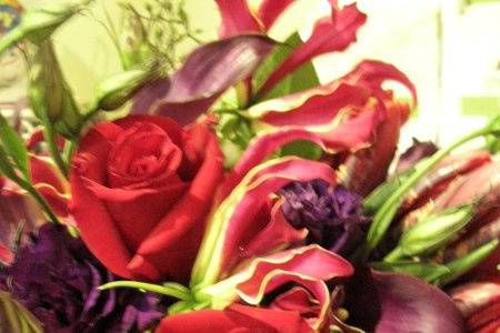 striking gloriosa lilies, parrott tulips, plum calla lilies, charlotte roses, purple lysianthus