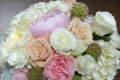Bouquet of exquisite garden roses in a variety of color, white hydrangea and poppy pods for that little bit of a different texture. Appropriate for either the Bride to carry or her bridesmaids.
