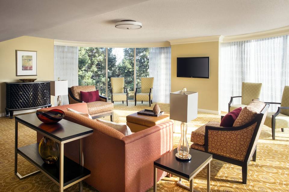 The presidential suite offers floor to ceiling windows with views of the surrounding redwoods, living room area with flat screen televisions, a separate dining area, prep kitchen, sleeping room with adjacent patio and large bathroom with upgraded amenities.