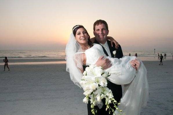 Groom carrying his bride