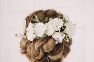 Braided updo complemented with white flowers