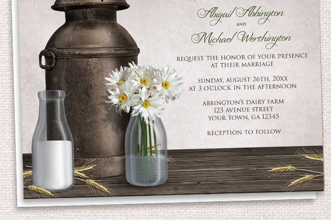 Country-inspired Wedding Invitations and optional matching RSVP reply cards, designed with a Dairy Farm wedding theme. They feature an antique milk can, 2 milk bottles (one with milk, the other with white daisies and water), a dark wood tabletop, and hay stems.