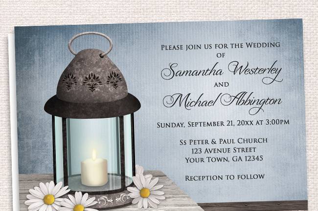 Country-inspired Wedding Invitations and optional matching RSVP reply cards, designed with a Lantern wedding theme. They feature an old but elegant ornate metal lantern with a lit candle inside and daisies around it, on a light wood tabletop, over a dark wooden floor, and a rustic blue or green background.
