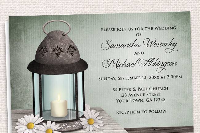 Country-inspired Wedding Invitations and optional matching RSVP reply cards, designed with a Lantern wedding theme. They feature an old but elegant ornate metal lantern with a lit candle inside and daisies around it, on a light wood tabletop, over a dark wooden floor, and a rustic blue or green background. (Found under the Lantern Blue listing)