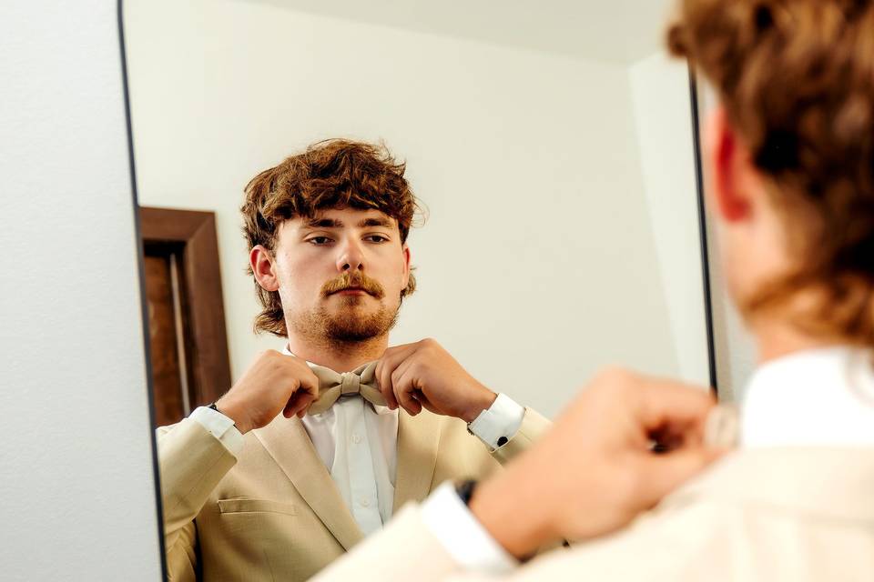 Groom getting ready in the pri