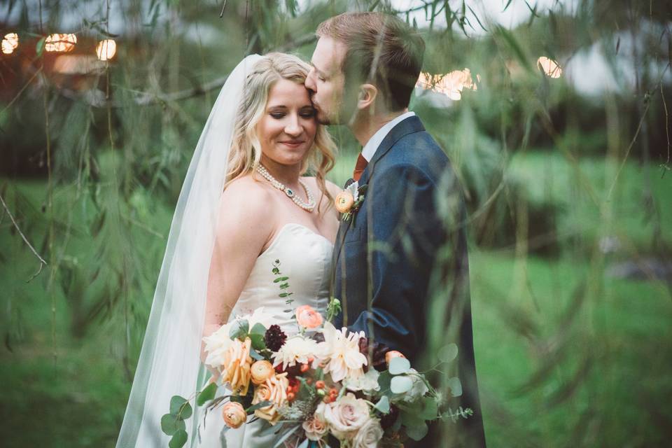 Groom kissing his bride