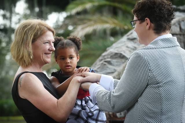 Christine and Dawn exchanging vows  in City Park with their 3 year old joining in. What a wonderful day!