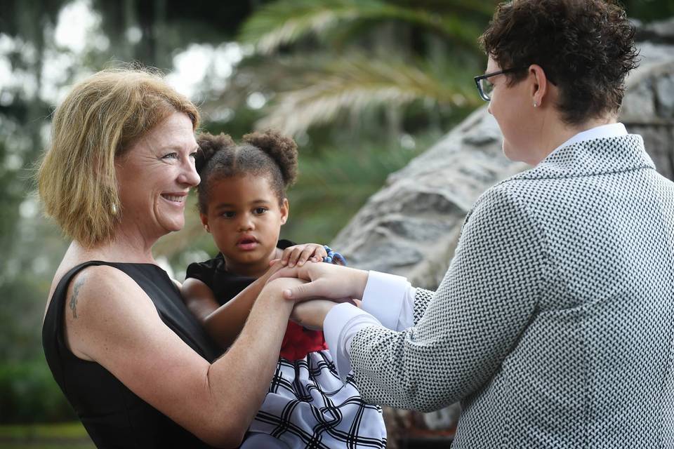 Christine and Dawn exchanging vows  in City Park with their 3 year old joining in. What a wonderful day!