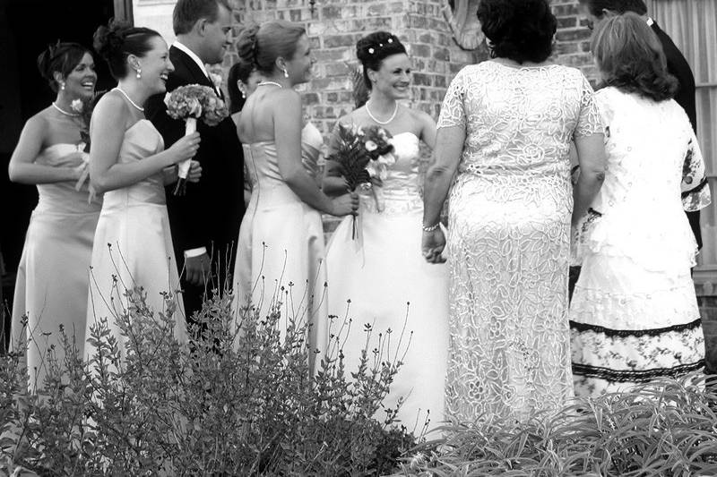 Wedding couple mingling with friends family and guests in black and white.