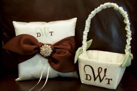 Love knot ring bearer pillow and matching flower girl basket.  Shown in satin with embroidered monogram and gorgeous rhinestone button accents.