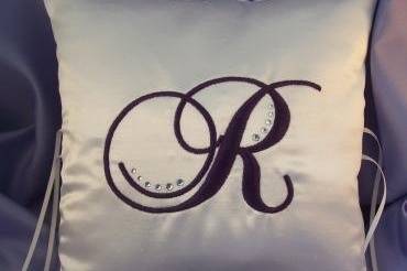 Ivory shantung ring bearer pillow with eggplant embroidered initial accented with Swarovski rhinestones.