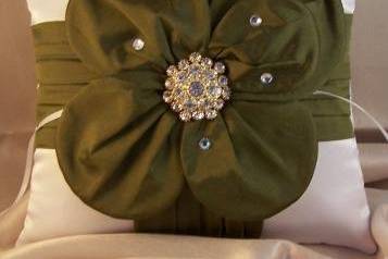 White satin taffeta pillow with olive dupioni silk flower finished with an amazing rhinestone brooch in the center and scattered Swarovski rhinestones.