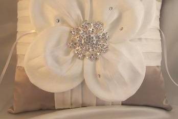 Amazing ring bearer pillow with a hand made satin flower accented with a vintage inspired center brooch and scattered Swarovski rhinestones... a touch of feathers too.