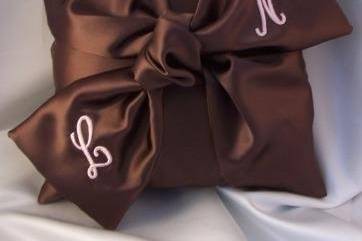 Shimmering chocolate satin love knot ring bearer pillow with pink initials.  Custom made.