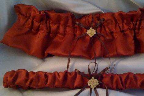Gorgeous cinnamon satin garter set with chocolate satin bows and a touch of fall with a golden maple leaf.  Bridal garter and tossing garter.