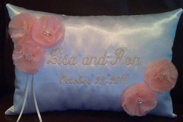 Custom satin shantung ring bearer pillow monogrammed with bride and groom's names and wedding date.  Accented with hand made organza flowers with center pearls and Swarovski rhinestones.