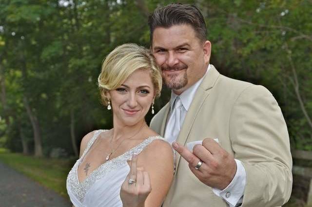 Bride and groom showing off their wedding bands