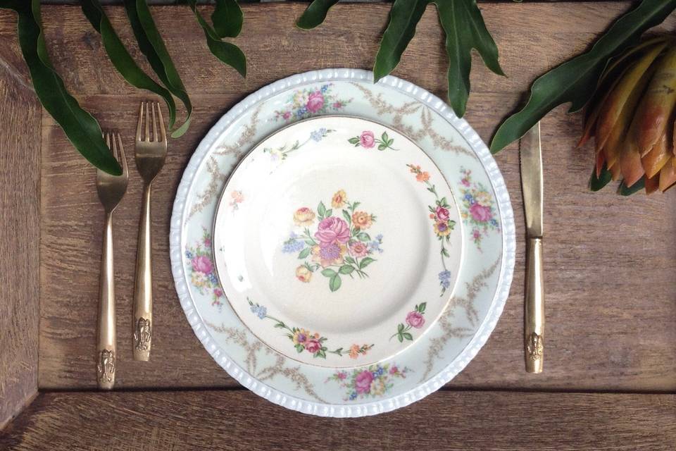 Mismatched vintage china with gold flatware