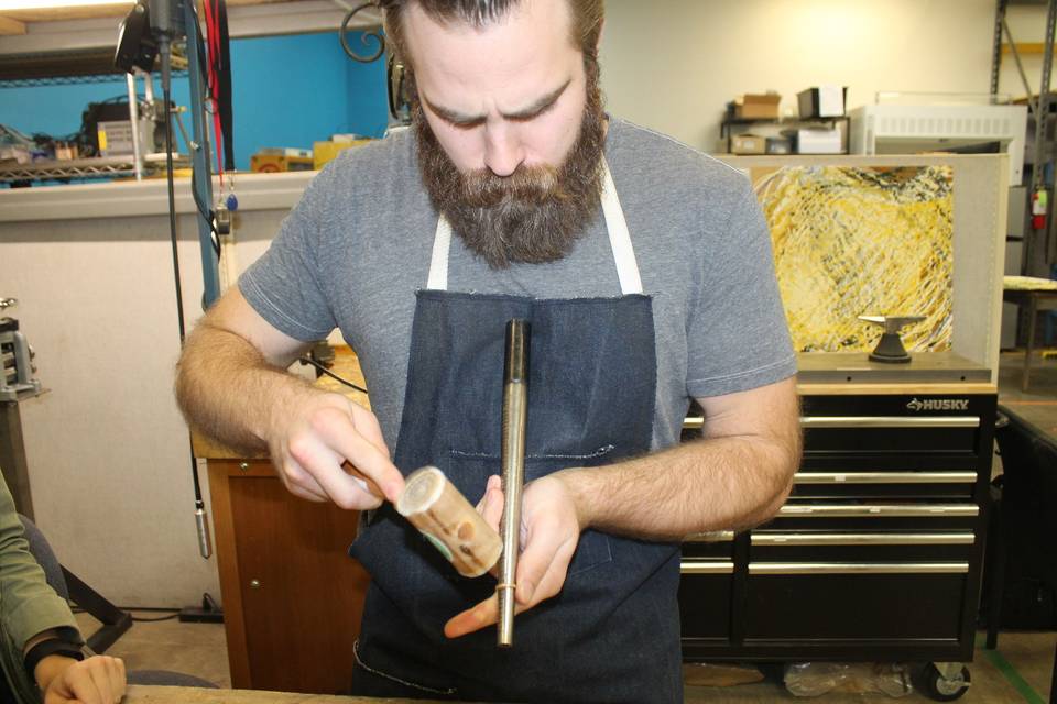 Zach shaping Ari's ring round.