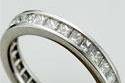 14k White gold channel set diamond eternity ring.  This ring can be made with princess cut (as shown), round, asscher cut, baguette cut, or square cut diamonds, as well as many different colored stones.