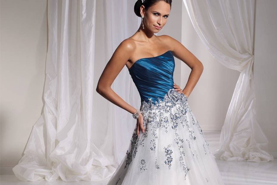 Y21152 - Concetta <br>
With its intricately embellished bodice, Concetta paints a perfect picture of traditional elegance in this Florentine satin ball gown. The baroque inspired hand-beaded and embroidered sweetheart bodice creates a dramatic effect while the skirt features exquisite floral and beaded appliqués which peak out from hand-draped pick-ups. A chapel length train and corset back finish off the dramatic look.