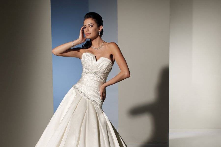Y21154 - Faith <br>
Faith will thrill and delight all the way down the aisle. This Marseille taffeta gown offers a softly curved neckline, beautifully draped bodice and gorgeous A-line silhouette with a superb fit. Hand-placed beaded lace appliqués on the bodice are highlighted with sequins and crystals. The full skirt features matching lace appliqués applied to a draped tulle overlay. A chapel length train and functional corset back finish off this romantic look. Removable straps included.