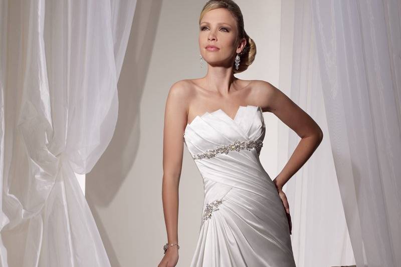 Y11106 - Aubrey
Sophisticated drama meets modern styling. Paris satin A-line gown Aubrey features a fantastically hand-pleated strapless zigzag neckline and hand-embroidered and beaded Empire waistband. The hand-draped bodice and skirt are pinched at the hip with a hand-beaded brooch. A beautifully draped back bodice with matching brooch and chapel length train finishes off this stunning gown. Removable straps included. Also available with detachable embroidered and beaded shoulder straps as Y11106A and, with back zipper as Y11106Z or Y11106AZ.