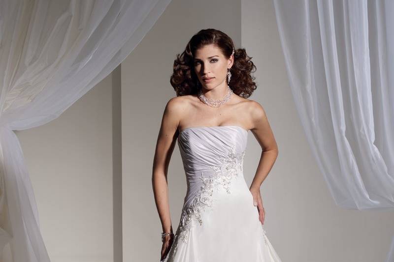 Y11117 -  Beatrix
Exceptional embroidery signifies Beatrix as one of the standout styles of the season. Beautifully hand placed flowers cascade down the asymmetric draped bodice and into the taffeta A-line silhouette which creates a stunning effect. A beautifully draped back and train also feature matching embroidery and flows into a chapel length train. A functional corset back completes this stunning dress. Removable straps are included. Also available with Paris satin skirt as Y11117A in Alabaster Ivory/Crystal Blue.