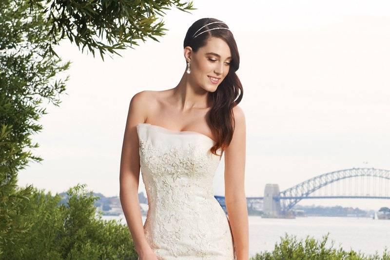 Y11328-Wiress <br>
Wiress features rich allover lace highlighted with delicate appliqués and glittering hand-beading with a soft mermaid skirt that flares into a chapel length train. A sweetheart décolletage is cleverly disguised by a lace bateau neckline. A gently curved open low back neckline with zipper closure and covered buttons will leave your groom wanting more.