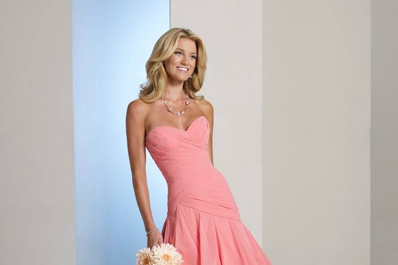 BY11224T
Strapless chiffon knee-length A-line dress with sweetheart neckline, directionally ruched bodice with asymmetrically dropped waistline and corset back. Removable straps included. Color Shown: Salmon. Available in all chiffon colors.