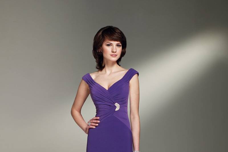 BY21267
Tip-of-the-shoulder jersey A-line gown with wide V-neckline, draped faux wrap bodice with side brooch accent, inverted Basque waistline.