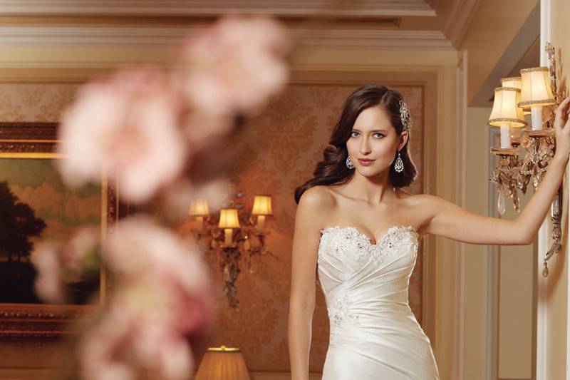 Style #Y11414<br>
Capturing all the elements of the season, Doreah will effortlessly transform any bride into a goddess. This slimming A-line Paris satin strapless gown features a sweetheart neckline adorned with crystal hand-beaded lace appliqués. Asymmetrical draping highlights the shapely silhouette flowing into the sheer lace appliqué hem with matching scalloped lace and chapel length train.