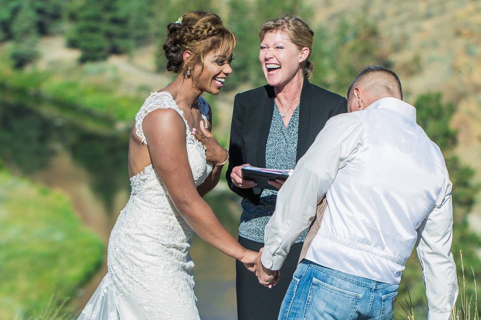 Officiant and couple laughing