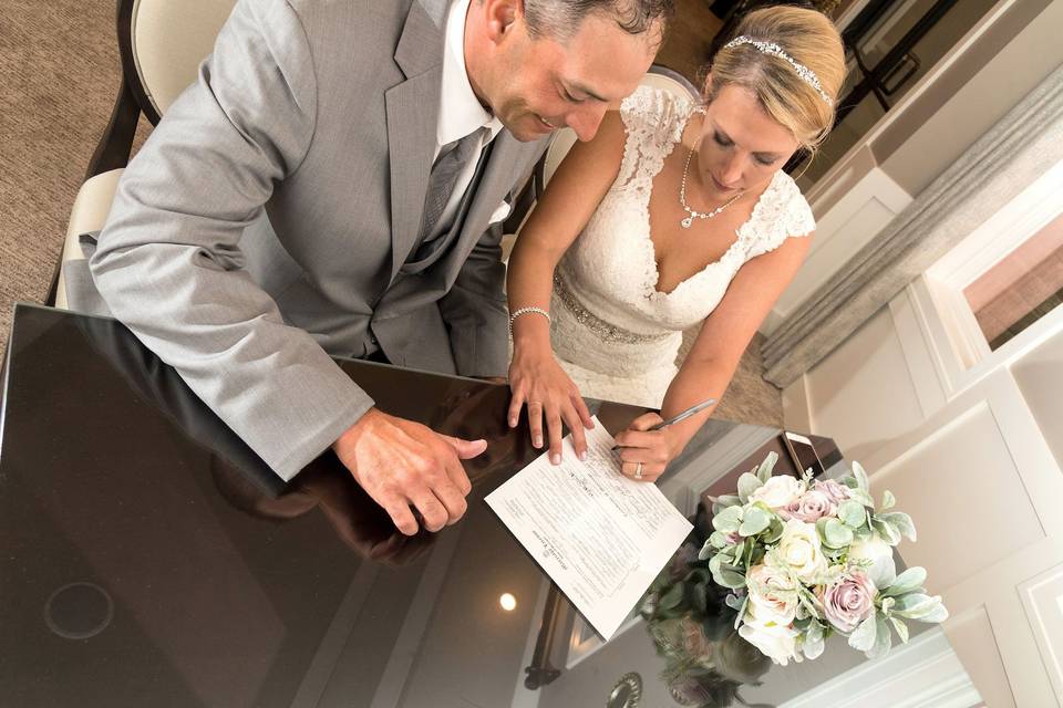 Officiant with marriage license signing