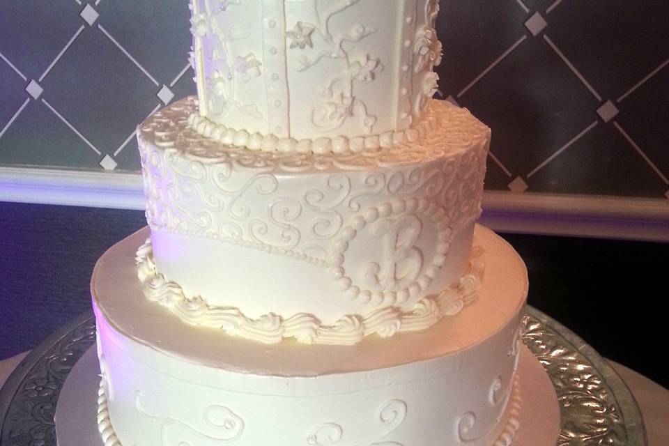Gluten free buttercream wedding cake with lace piping and monogram