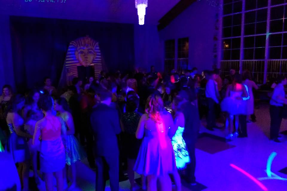 Here is the homecoming dance we did late last year. The young adults and the staff all had a great time. We had fun as well. Check out the script laser in action near the top of the frame, We can display your text with laser light! We had the UV light on as well as you can see from all the cool effects on the crowds attire.