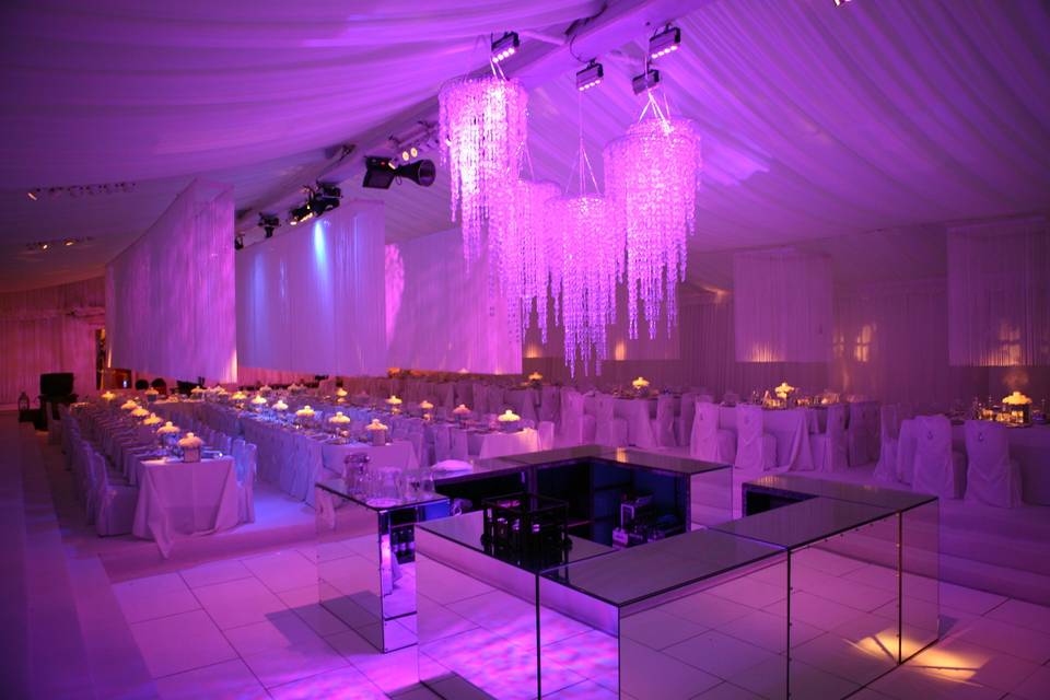 Stunning lighting effects and chandeliers in a marquee wedding reception