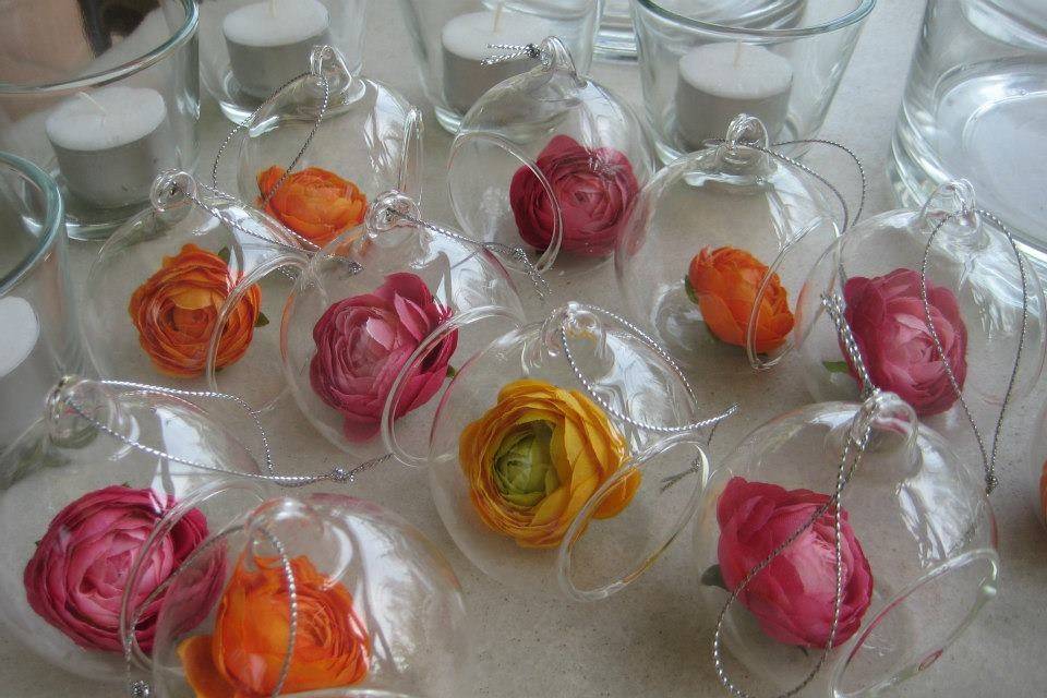 glass baubles with multi coloured flowers for hanging in the trees in Villa garden, Spain