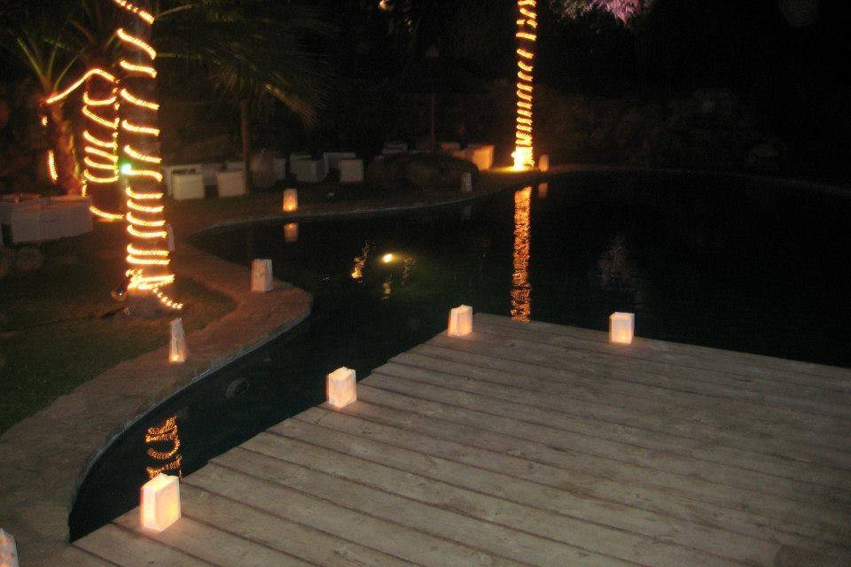 Poolside candles and tree lights for evening wedding party, Spain