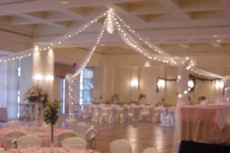 Chair covers with floral additions to the bows softly accent the linens on the guest table and the draping of the head table