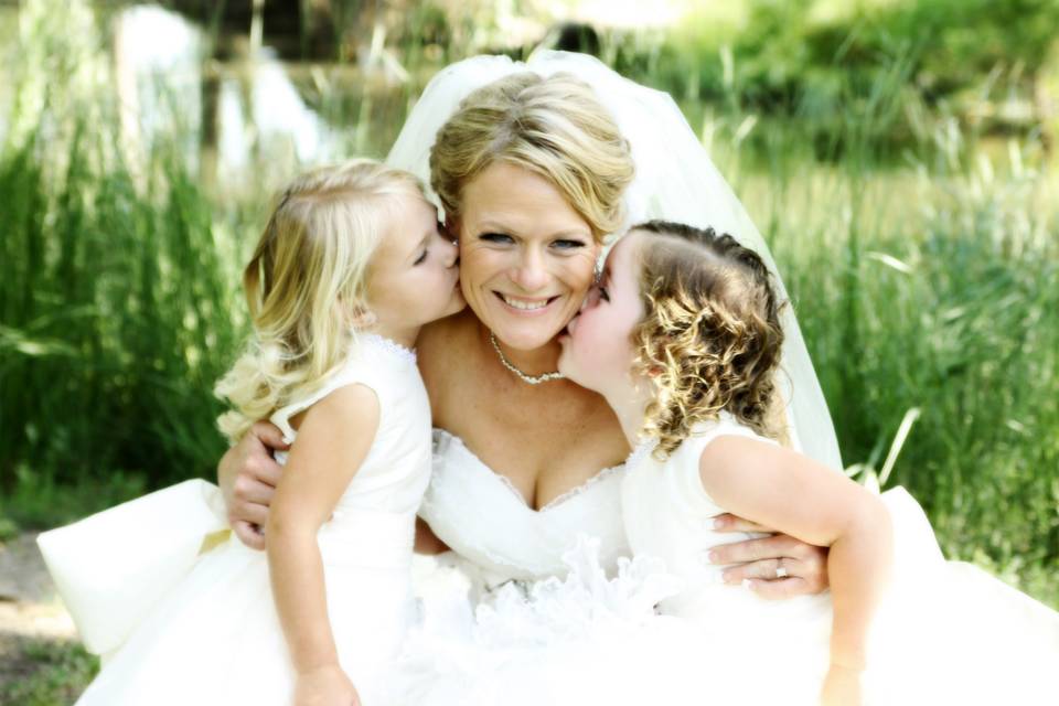 Bride with flower girl kiss