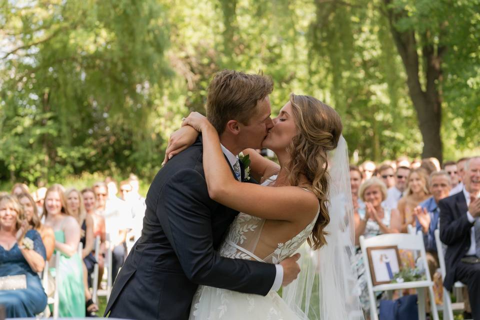 Kiss at wedding with guests