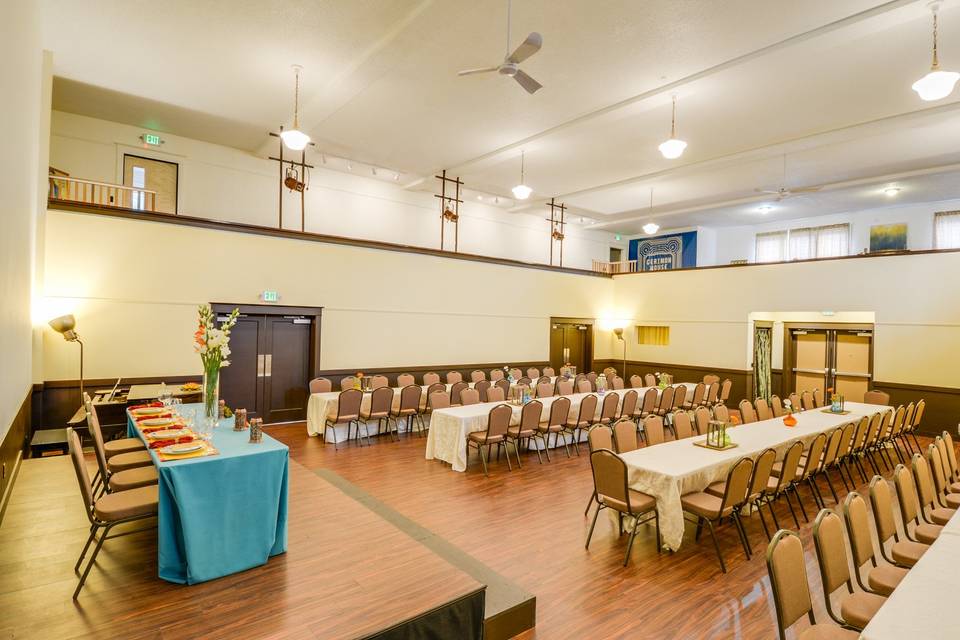 The Main Ballroom is a wonderful, large gathering space. Perfect for wedding Ceremonies, Receptions, Galas, lectures, presentations, play readings, workshops, and celebrations. This room can fit 125 for a cocktail reception, 100 seated guests (chairs and tables in picture shown).The room measures 39' X 39' and has 6 different entrances and exits. This marvelous hall features a wrap around balcony along three sides, a stage, a baby grand piano, and a projection wall (high-quality Epson projector available to rent for an additional fee).Located on our main floor, this room is completely ADA-accessible and ready for your event.