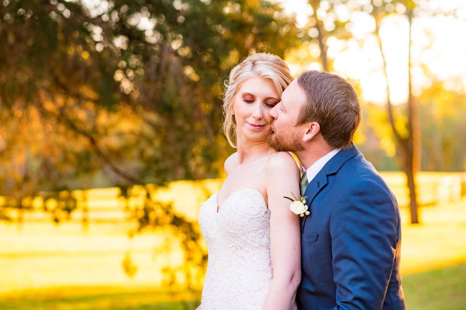 Couple kissing in a pasture