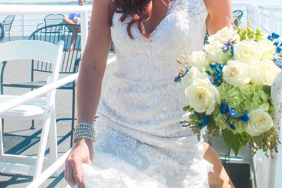 The beautiful bride walking down the aisle of the SOLARIS yacht sky deck in Destin Fla.