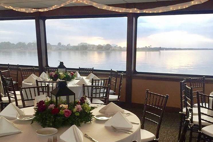 Accent lighting and floral centerpieces for this yacht wedding and reception for the SOLARIS Yacht Sandestin Florida, created by in-house wedding planners